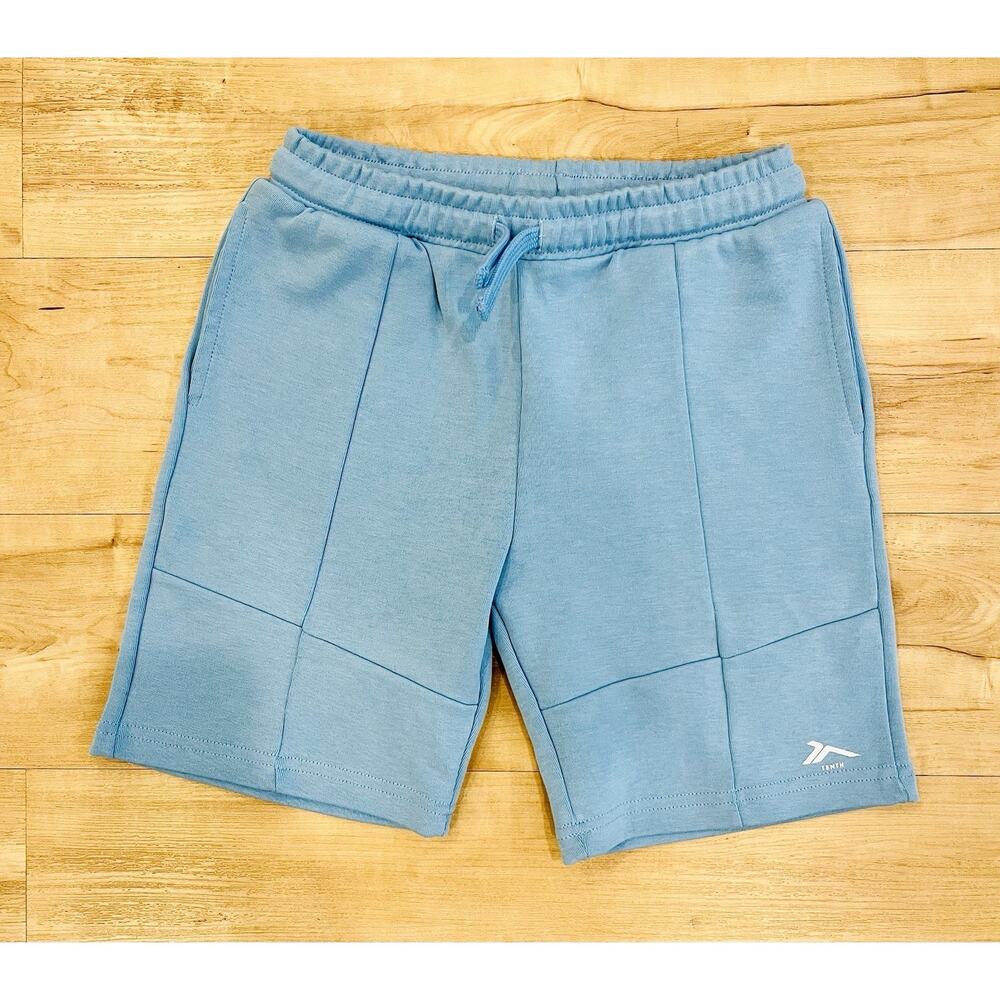 a pair of light blue Tenth brand shorts designed in Spain. Youth US Size 10-12